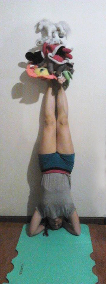 Asking my sister to be upside down so I can put stuffed animals on her feet.